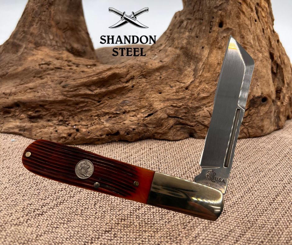 Pocket knife with wooden handle and metal blade on a textured surface with 'Shandon Steel' branding.