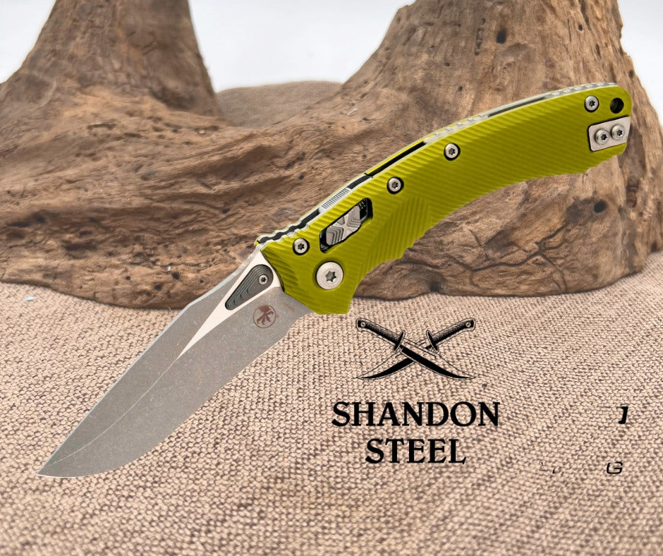 Folding knife with green handle on a textured surface, Primemartshop logo visible