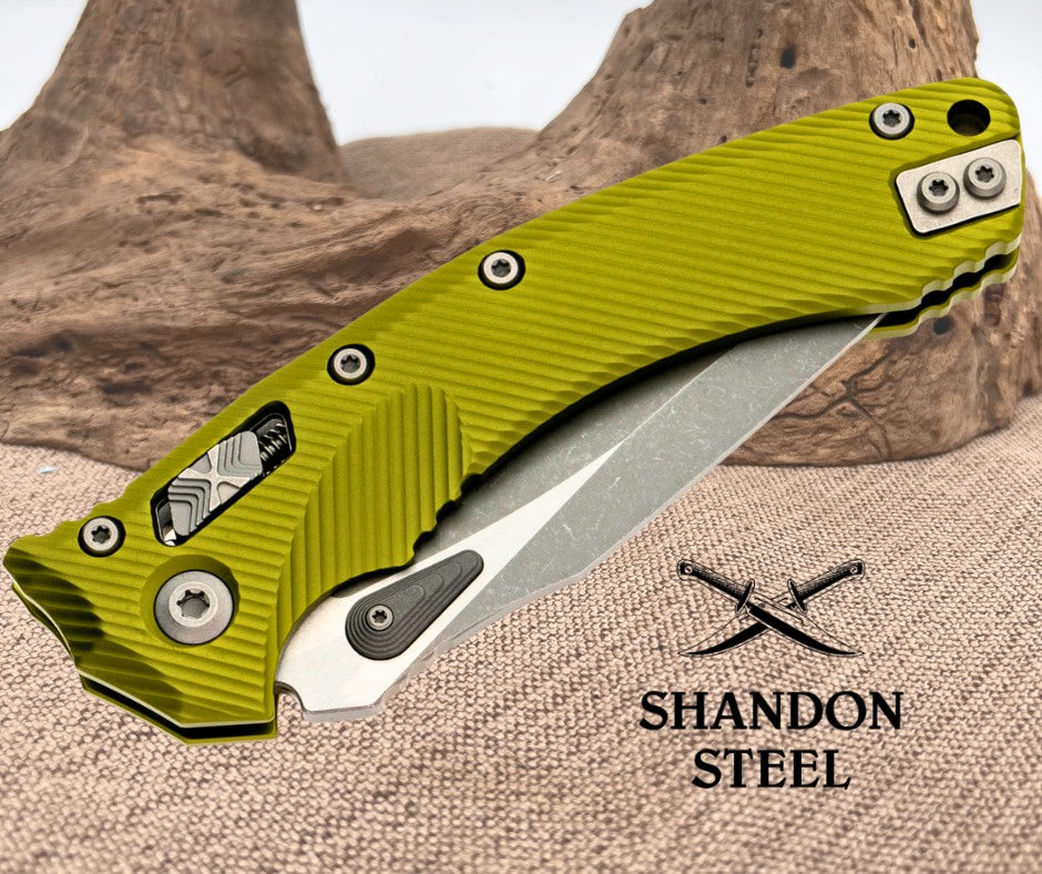 Green folding knife with 'Shandon Steel' branding on a textured surface