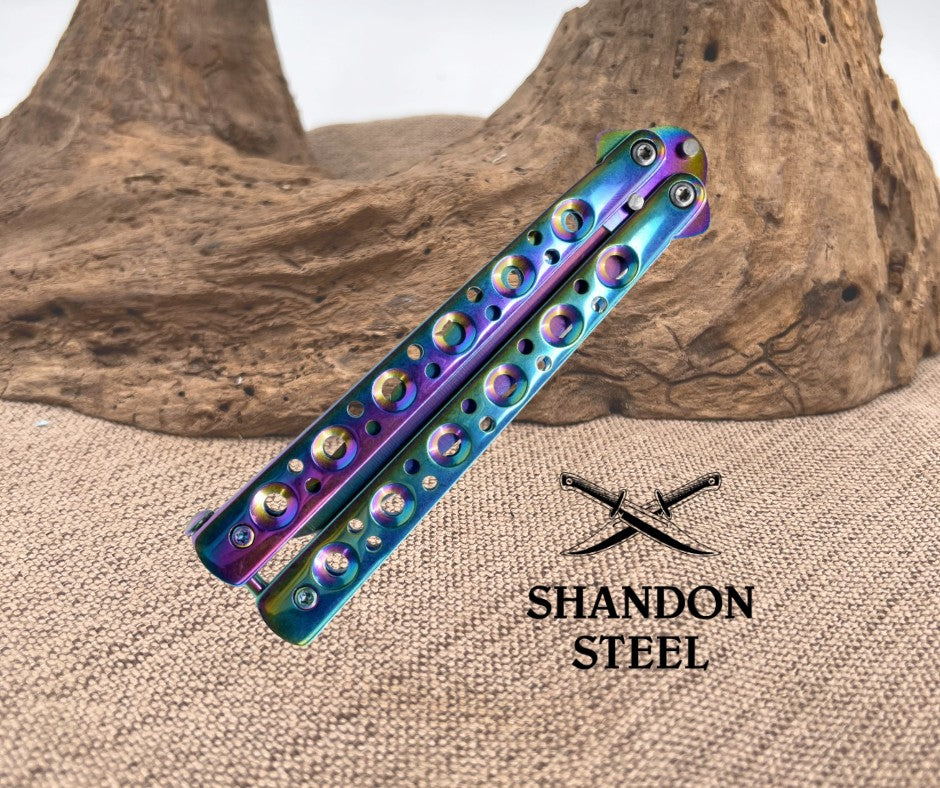 Colorful folding knife with 'Shandon Steel' branding on a textured surface.